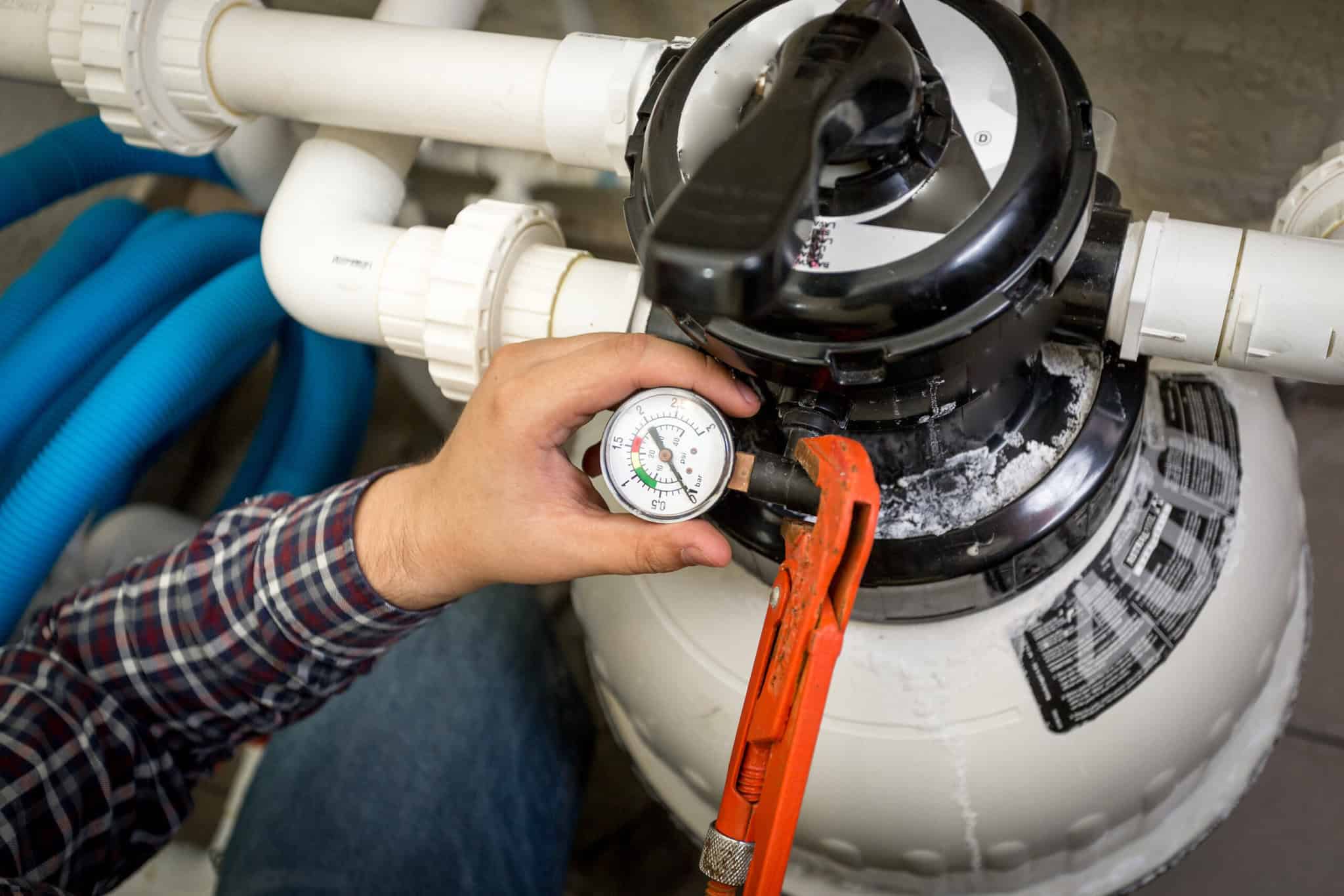 Closeup shot of plumber checking manometer on big hydraulic pump