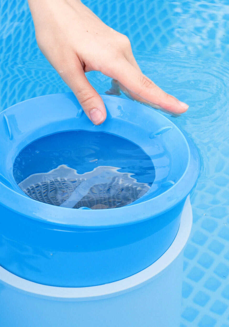 girl cleans skimmer for the frame pool. contaminated pool cleaning concept girl cleans skimmer for the frame pool. contaminated pool cleaning concept