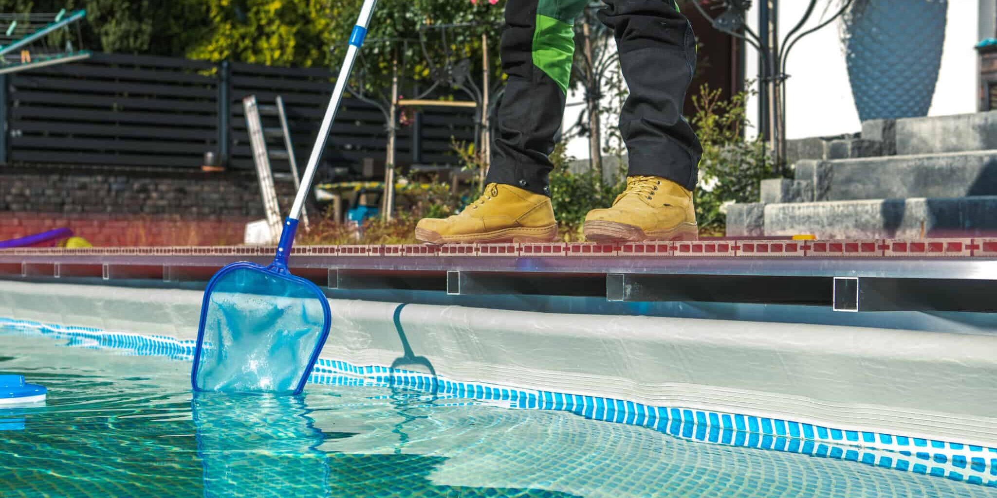 poolside maintenance worker cleaning water surface with a net poolside maintenance worker cleaning water surface with a net