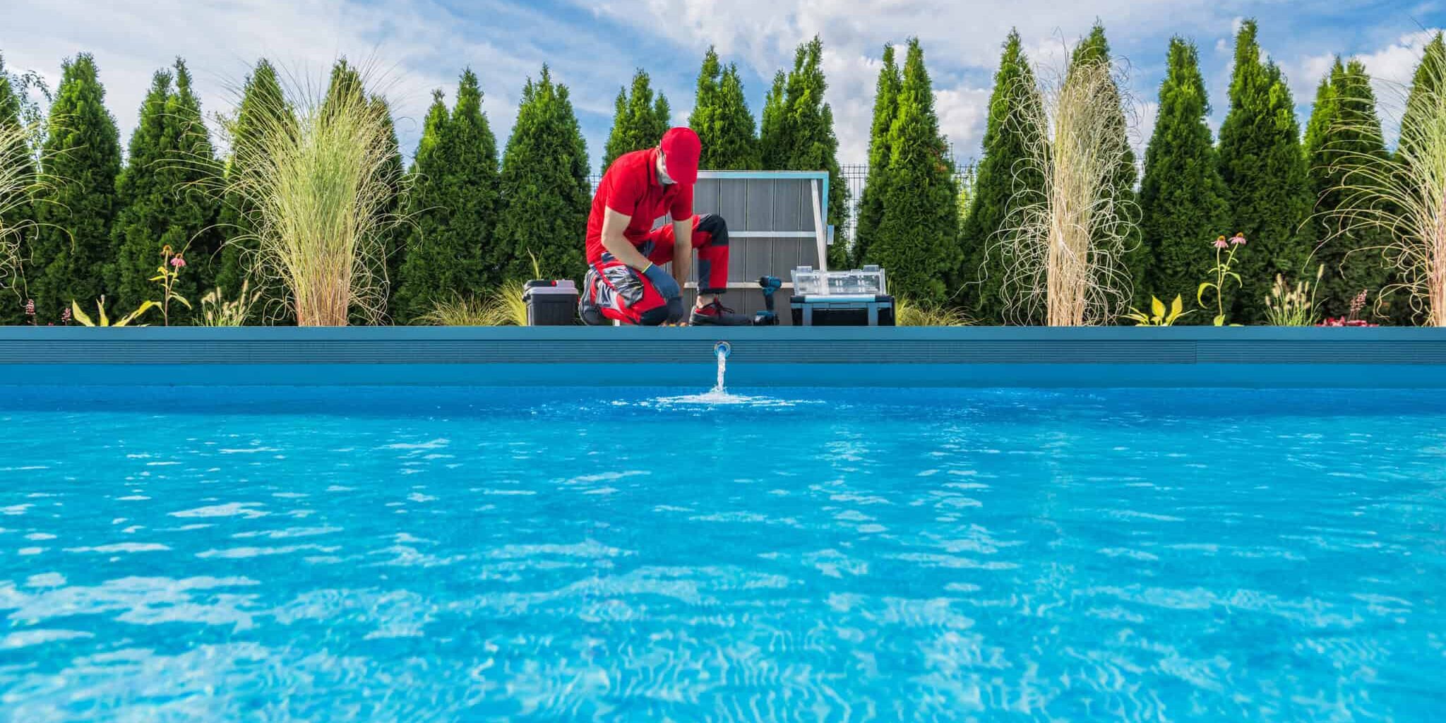 Professional Swimming Pools Technician Performing Seasonal Maint Professional Caucasian Swimming Pools Technician in His 40s Performing Seasonal Maintenance. Outdoor Residential Backyard Pool.