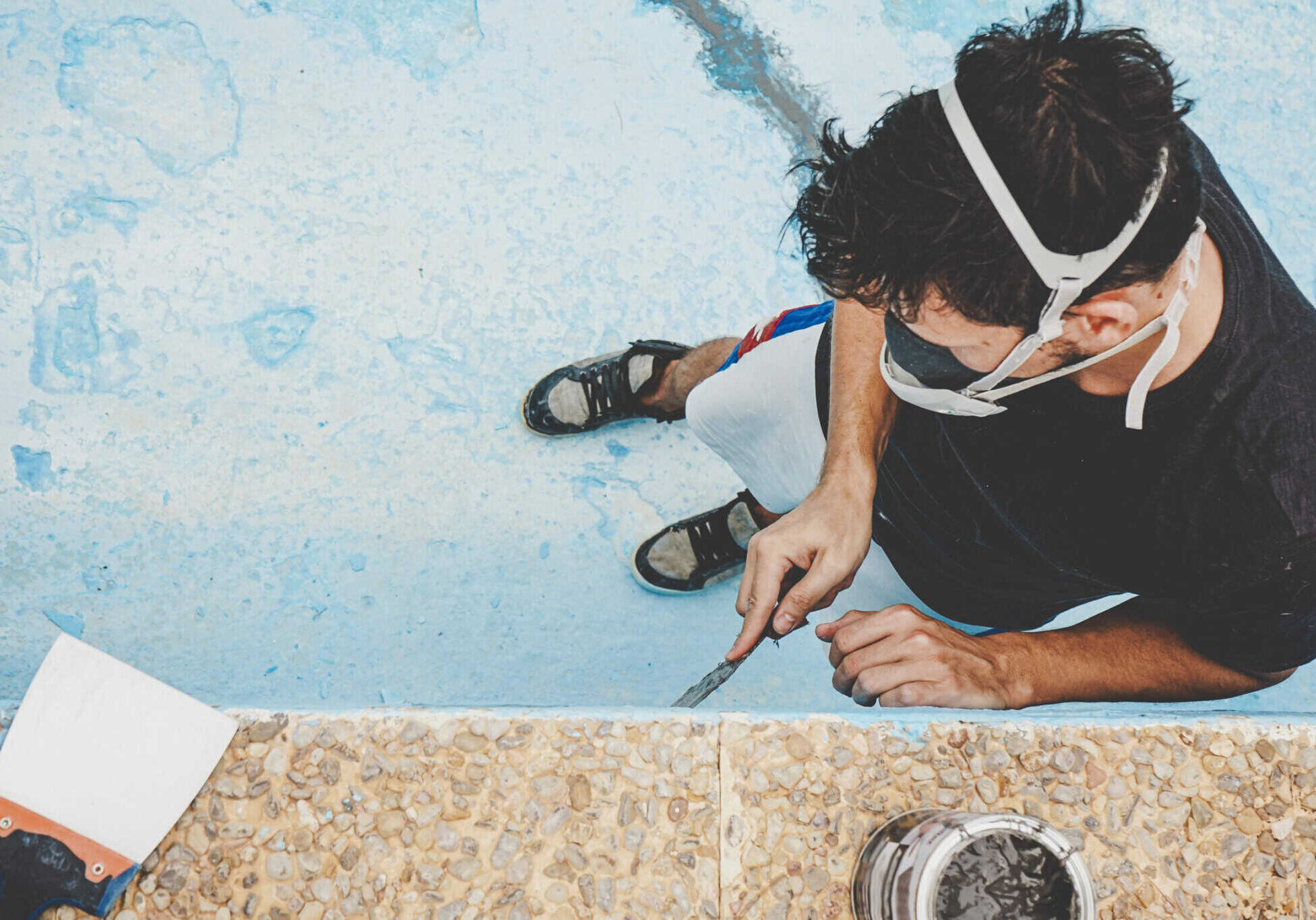 young man working in his swimming pool